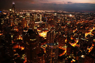 Aerial view of illuminated buildings in city at night