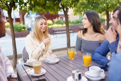 Women sitting on table at cafe