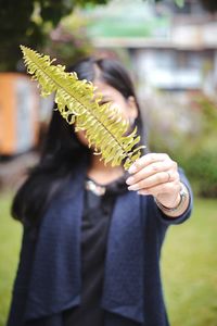 Midsection of woman holding plant