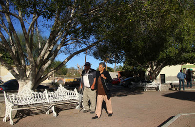 Rear view of people walking on bridge