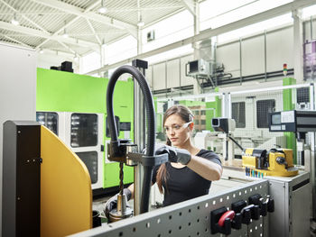 Young woman working on a machine