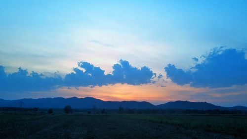 Scenic view of field against sky during sunset