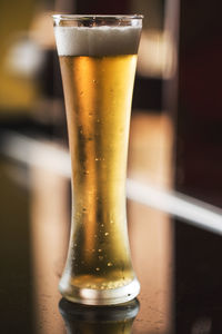 Close-up of beer glass on table