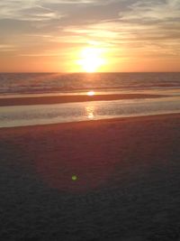 Scenic view of beach against sky during sunset