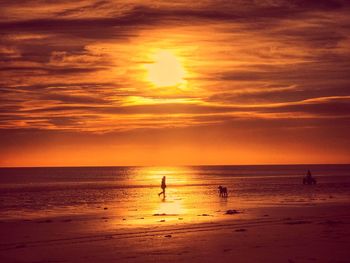 Scenic view of sea against orange sky