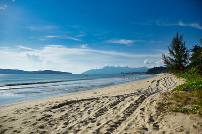 Scenic view of beach against blue sky