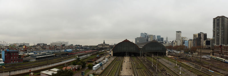 High angle view of city buildings against cloudy sky