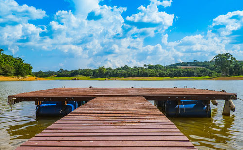 Pier over lake against sky