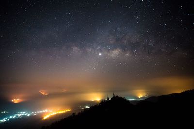 Scenic view of silhouette mountain against sky at night