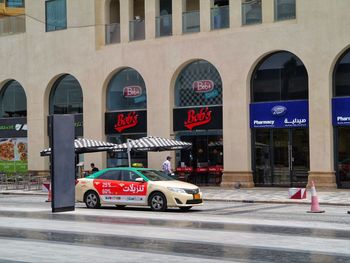 Cars on road against buildings in city