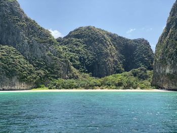 Scenic view of sea and mountains against sky