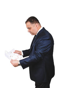 Side view of young man against white background