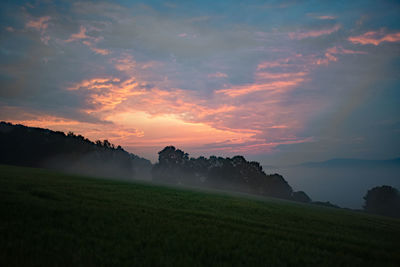 Scenic view of field against sky during sunset