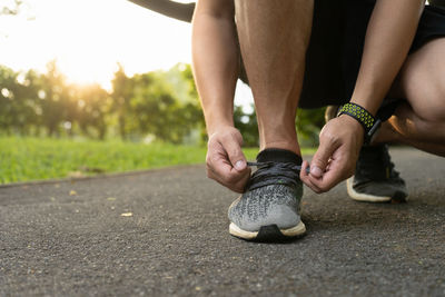 Low section of woman legs on road