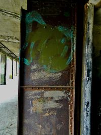 Close-up of rusty metal door of old building