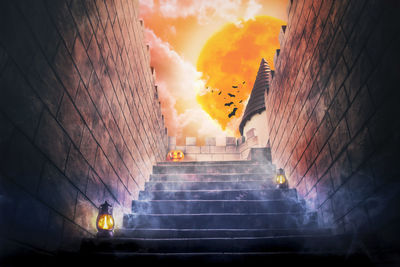 Low angle view of staircase amidst buildings against sky during sunset