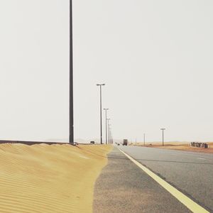 Empty road along trees