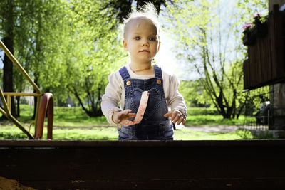 Portrait of cute baby girl standing outdoors