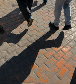 Low section of people walking on footpath