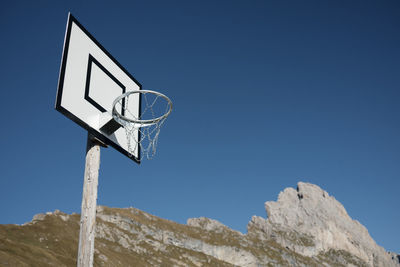 Low angle view of basketball hoop against blue sky