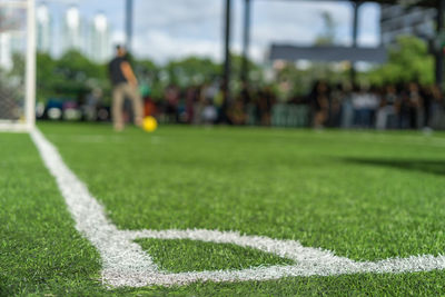 Surface level of soccer field against blurred background