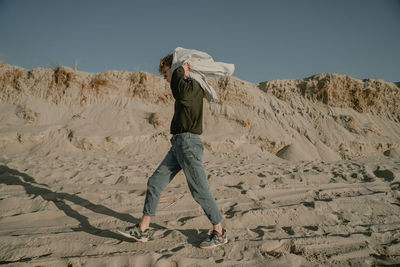 Side view of man walking on beach