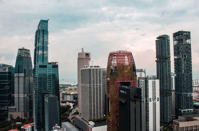 View of skyscrapers against cloudy sky