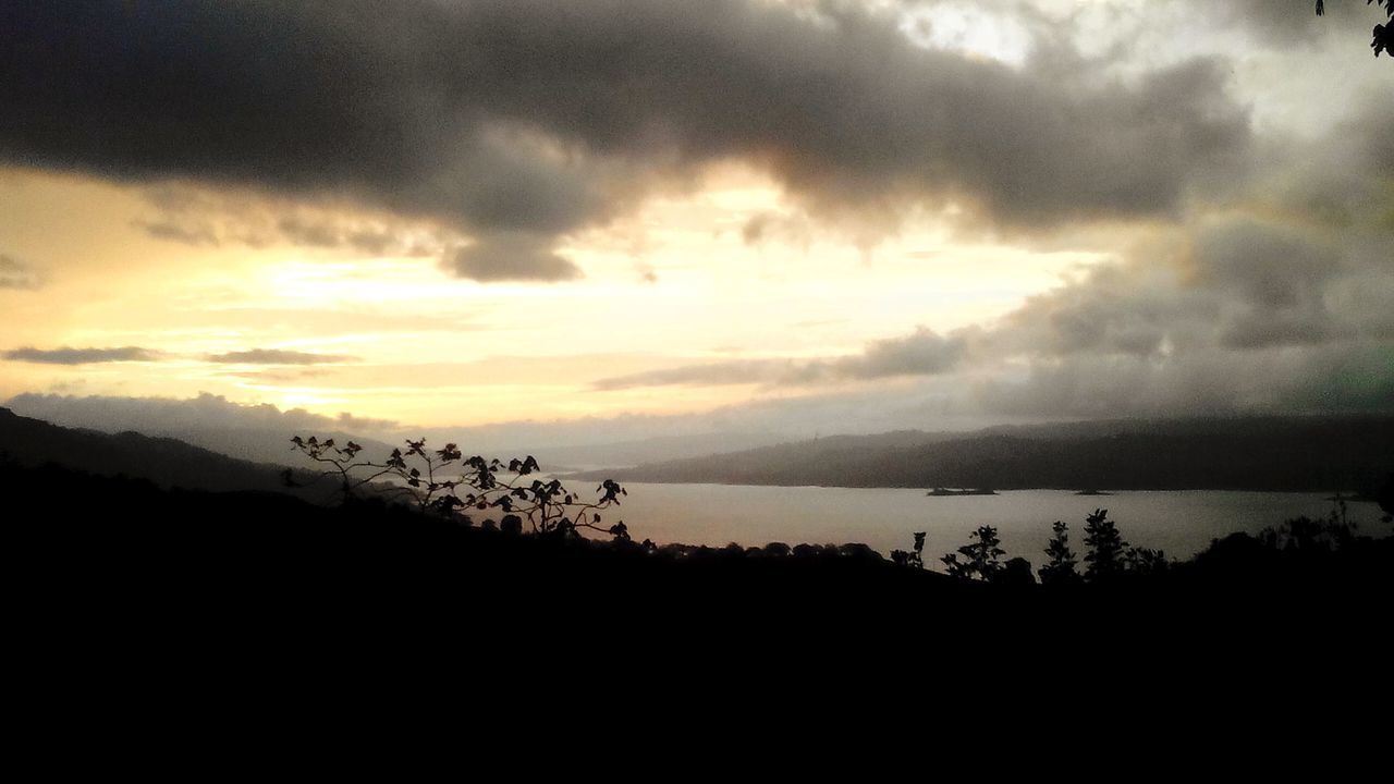 tranquil scene, scenics, tranquility, sky, silhouette, beauty in nature, sunset, cloud - sky, nature, idyllic, water, cloudy, cloud, mountain, tree, landscape, non-urban scene, dusk, outdoors, sea