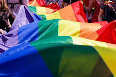 Rainbow flag in city on sunny day