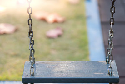 Wooden chain swing at playground.