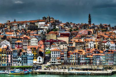 View of cityscape against cloudy sky