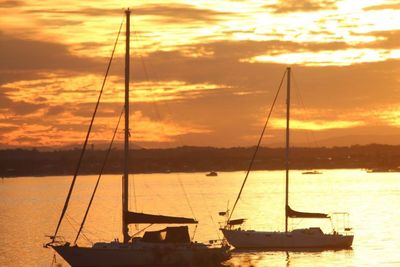 Sailboat in sea at sunset