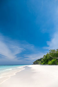 Scenic view of beach against blue sky