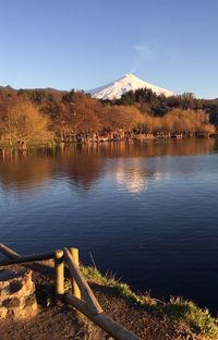 Calm lake with mountains in background
