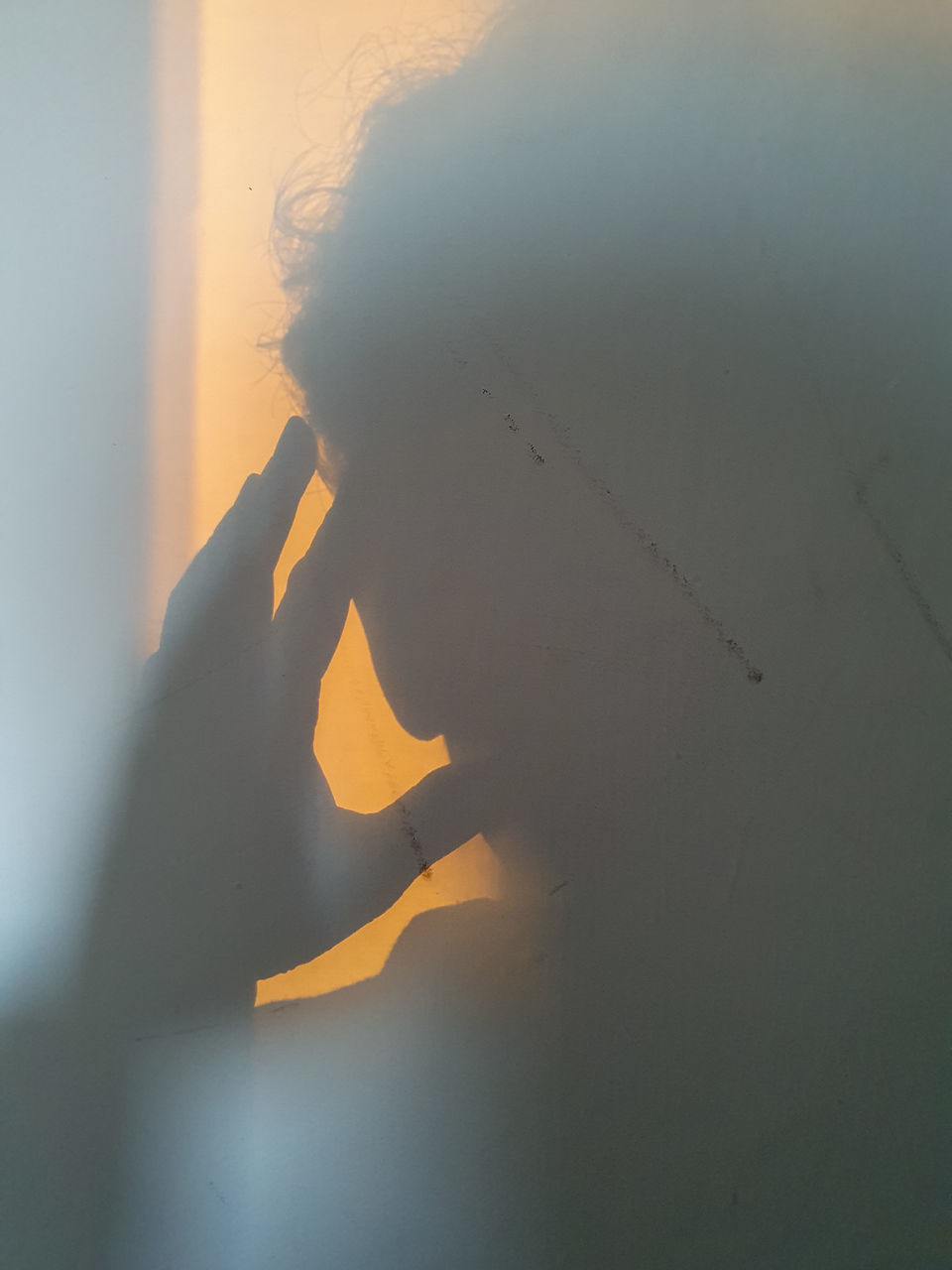 PORTRAIT OF YOUNG MAN SMOKING ON WALL