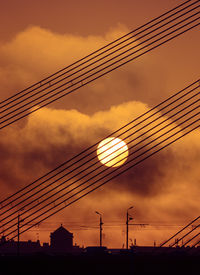 A beautiful riga cityscape with suspension bridge over the river during colorful sunrise. 