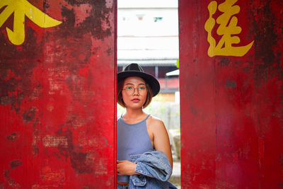 Portrait of woman standing at door