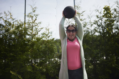 Woman participating in sports competition throwing ball
