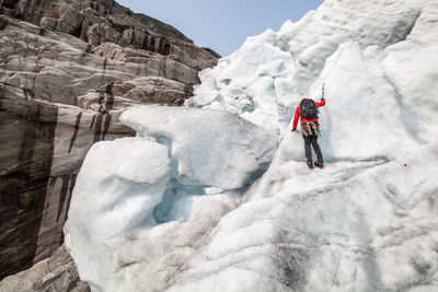 Rear view of person ice climbing 