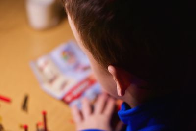 Rear view of boy playing at home