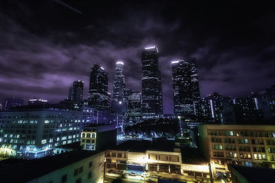 Low angle view of illuminated buildings against sky at night