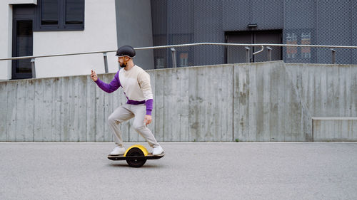 Man using smart phone standing on balance board