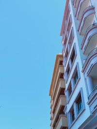 Low angle view of modern building against clear blue sky