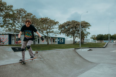 Full length of man skateboarding on skateboard against sky