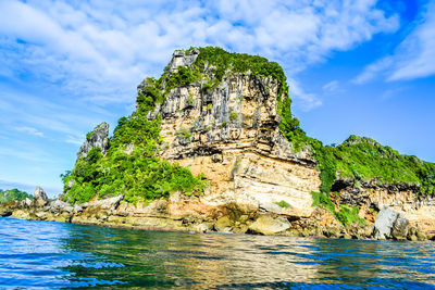 Rock formation amidst sea against sky
