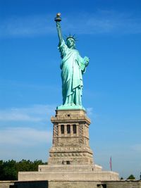 Low angle view of statue against cloudy sky