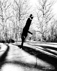 Full length of man jumping on road