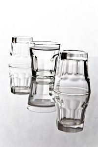 Close-up of empty glasses on white background