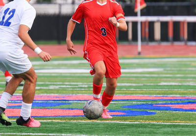 Man playing soccer at park