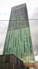 Low angle view of building against cloudy sky